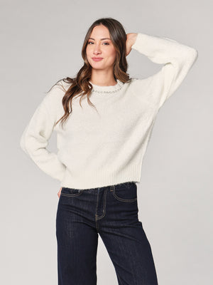 Maglia con paillettes e applicazioni