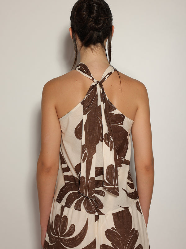 Top in fantasia floreale con gioello